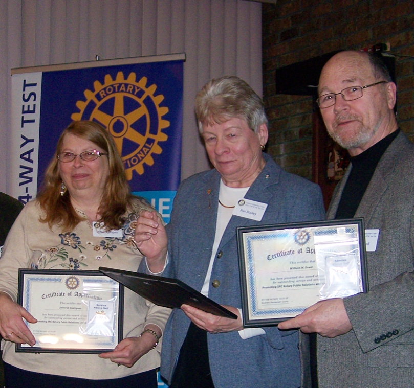 From left: Debbie Rodriguez, Pat Bailey, and Bill Dowd receive a "Rotary Visibility" award.